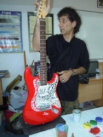 Senol Özdevrim in his art class with glass mosaic on guitar